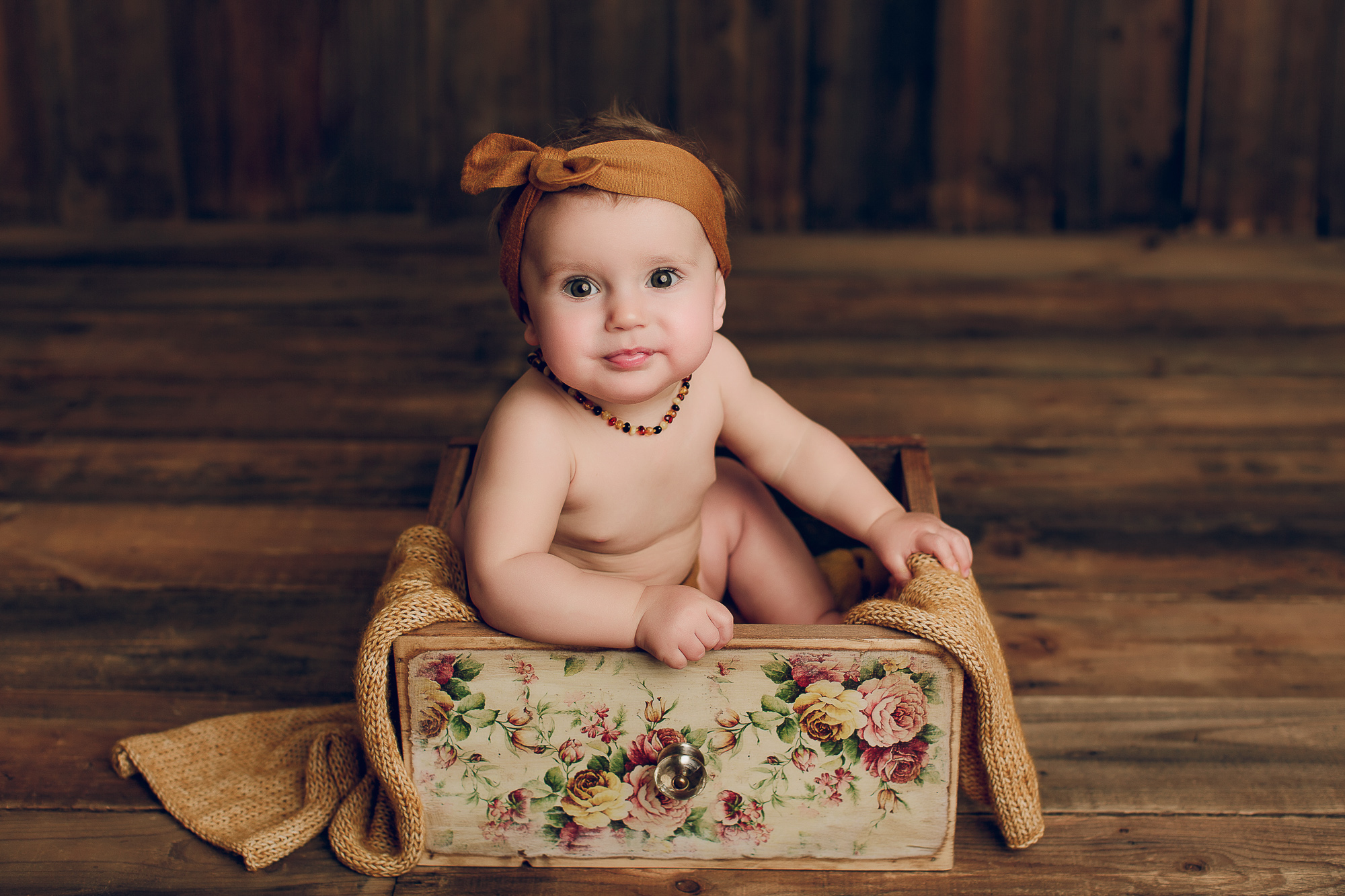 Adelaide baby photographers photo of a 9 month old baby girl sitting.