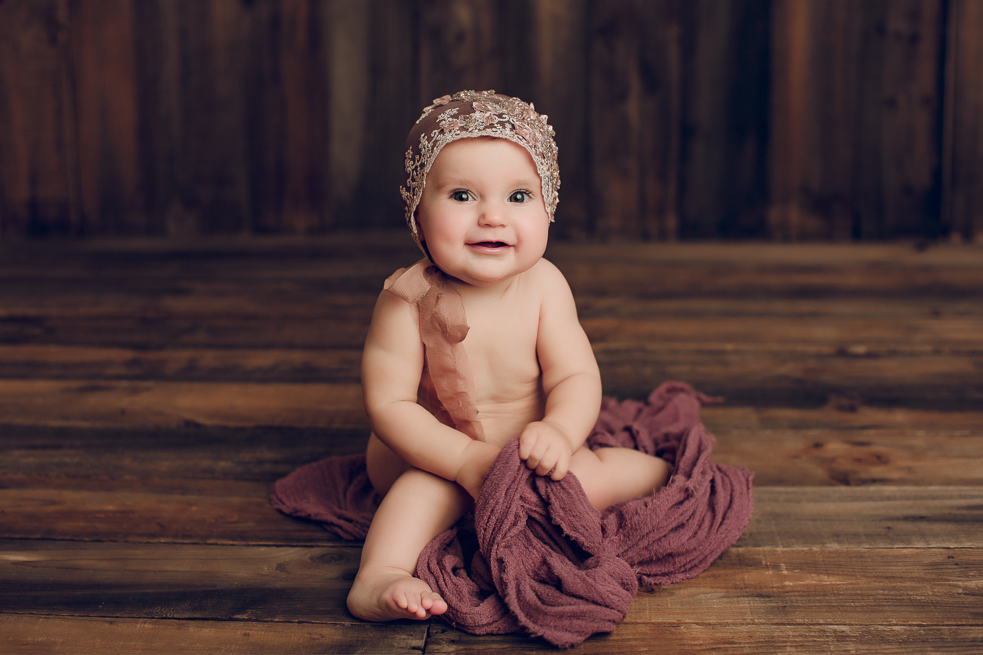 Adelaide baby photographers photo of a 9 month old baby girl sitting.