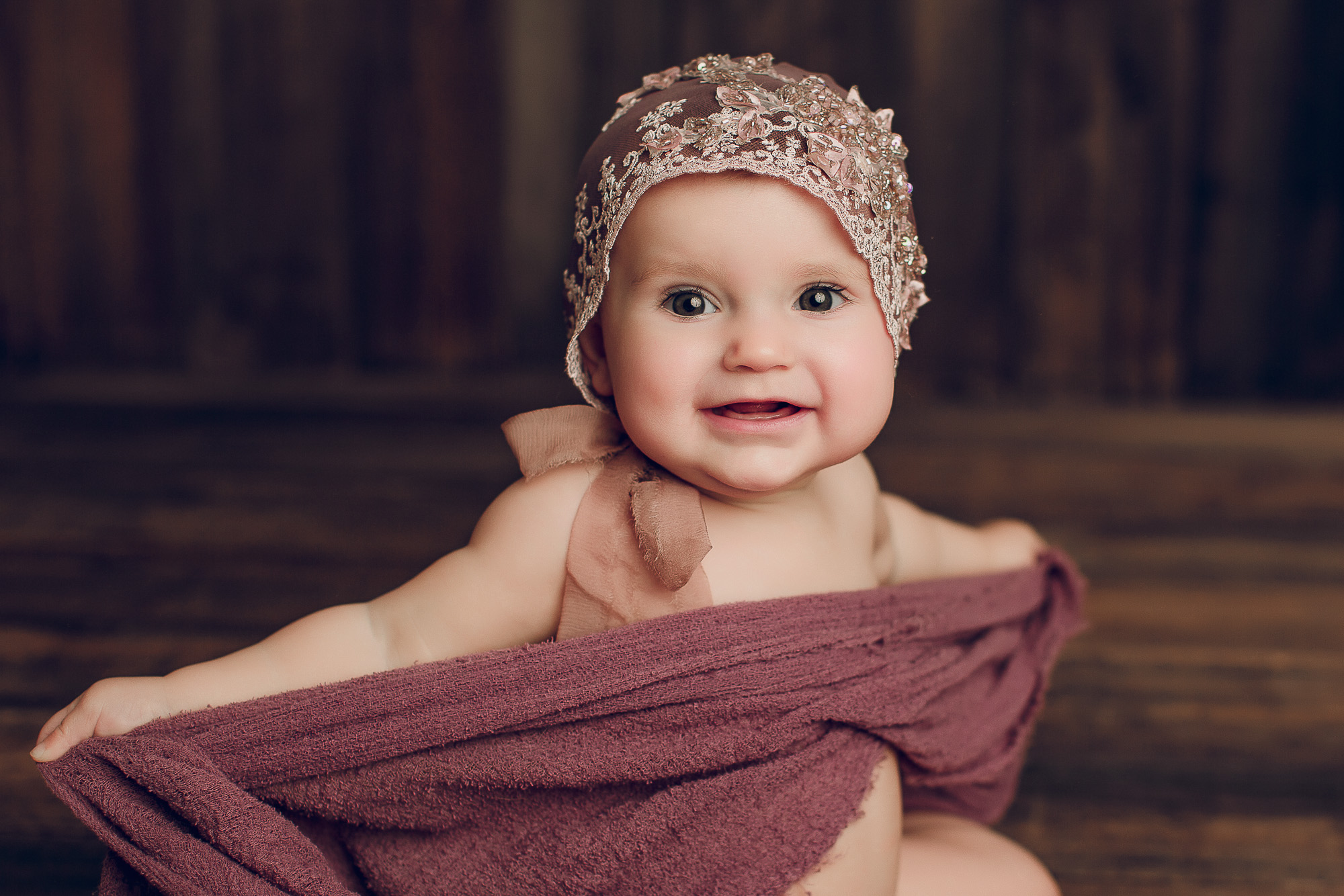 Adelaide baby photographers photo of a 9 month old baby girl sitting.