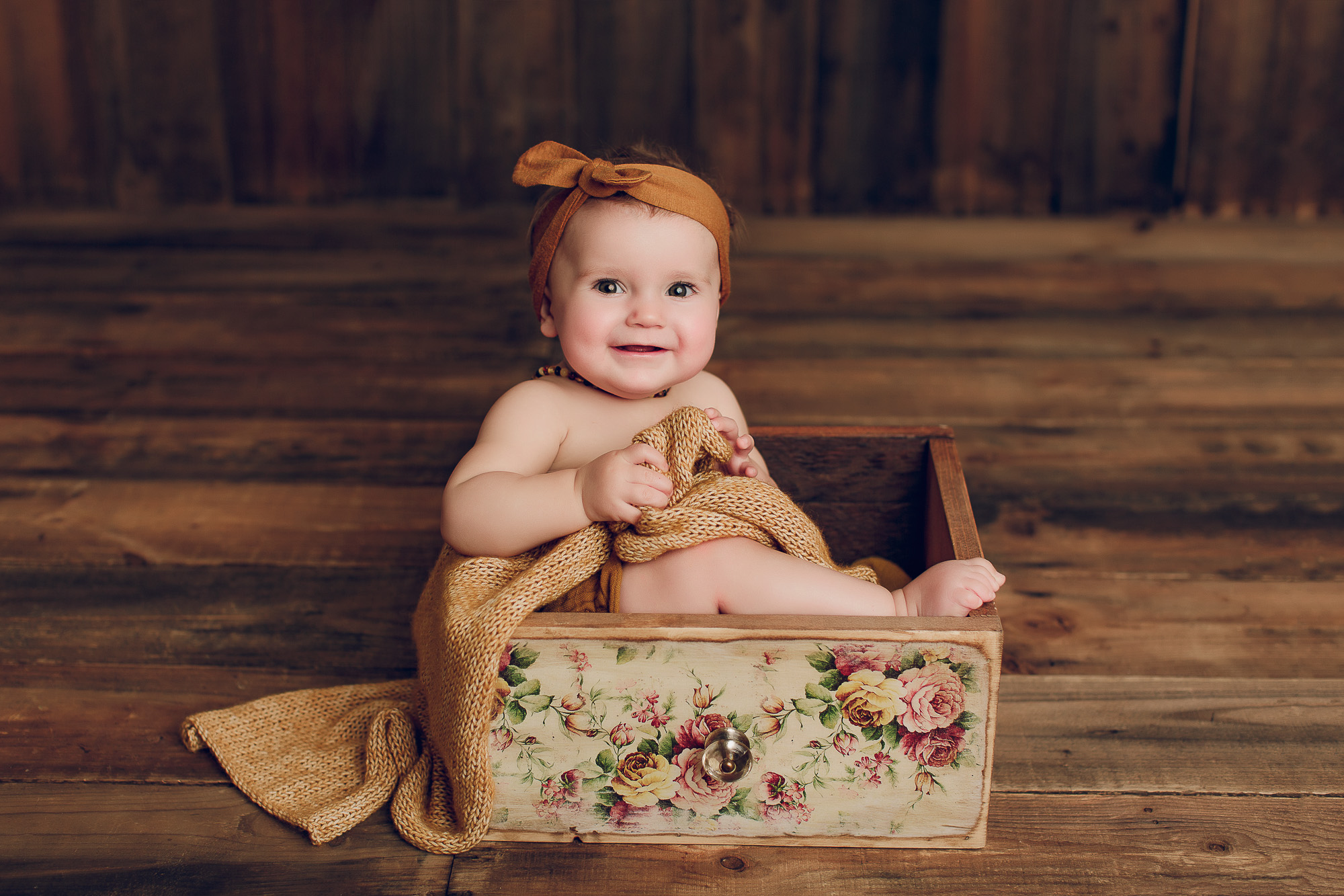 Adelaide baby photographers photo of a 9 month old baby girl sitting.