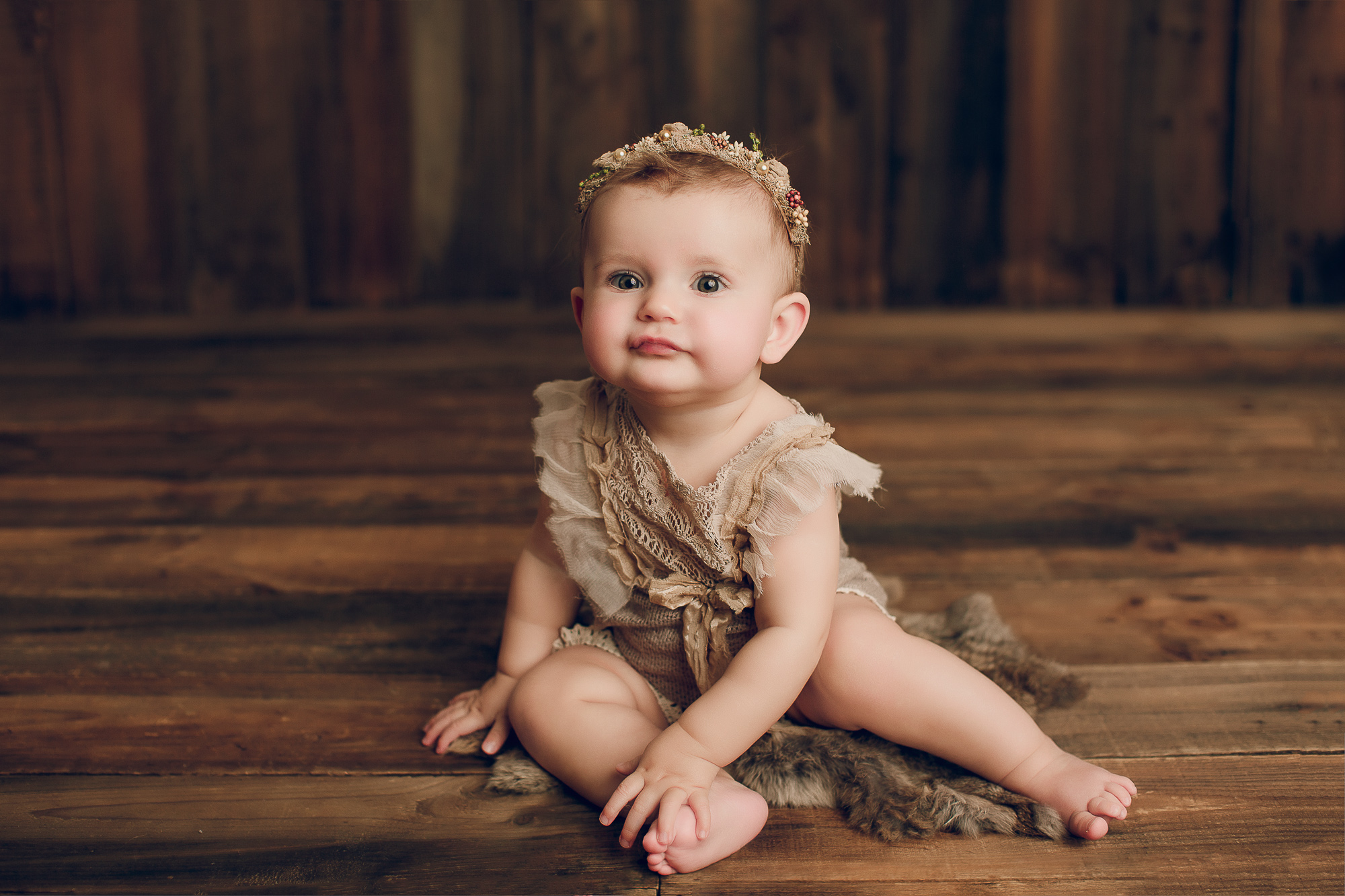 Adelaide baby photographers photo of a 9 month old baby girl sitting.