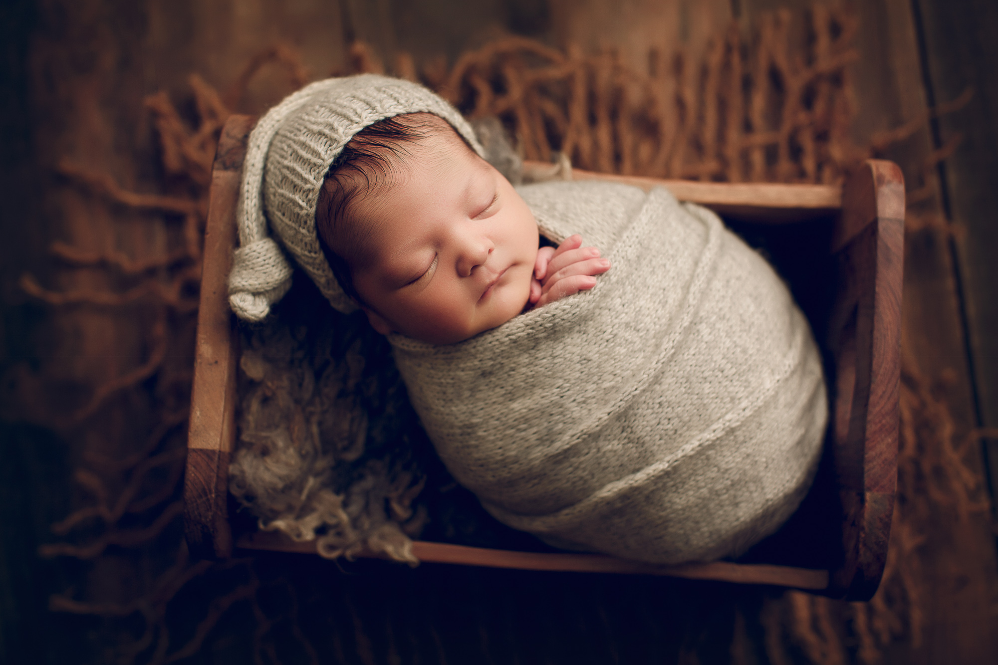 Adelaide Newborn photography photo of a newborn baby asleep in a bed.