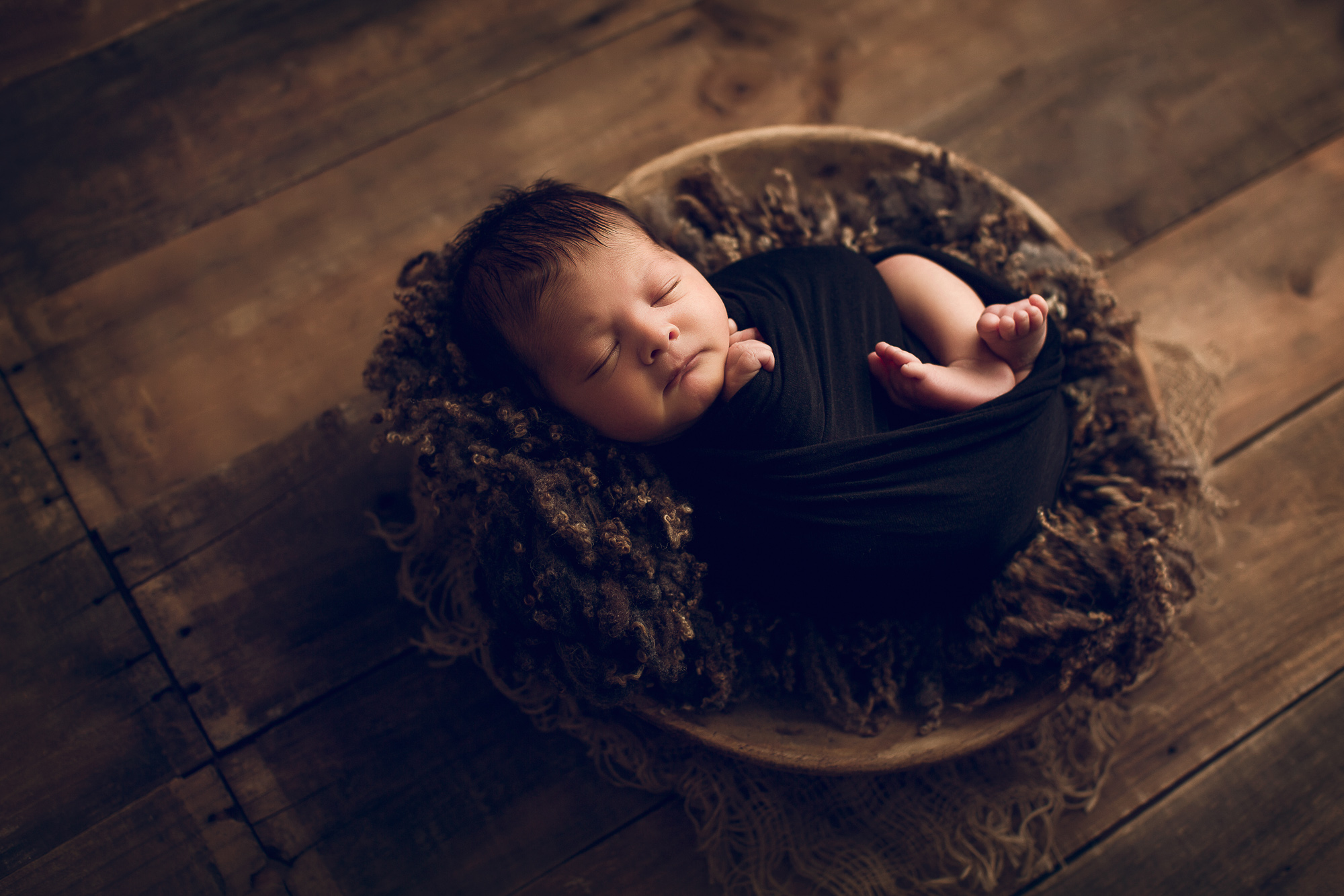 Adelaide Newborn photography photo of a newborn baby asleep in a basket.