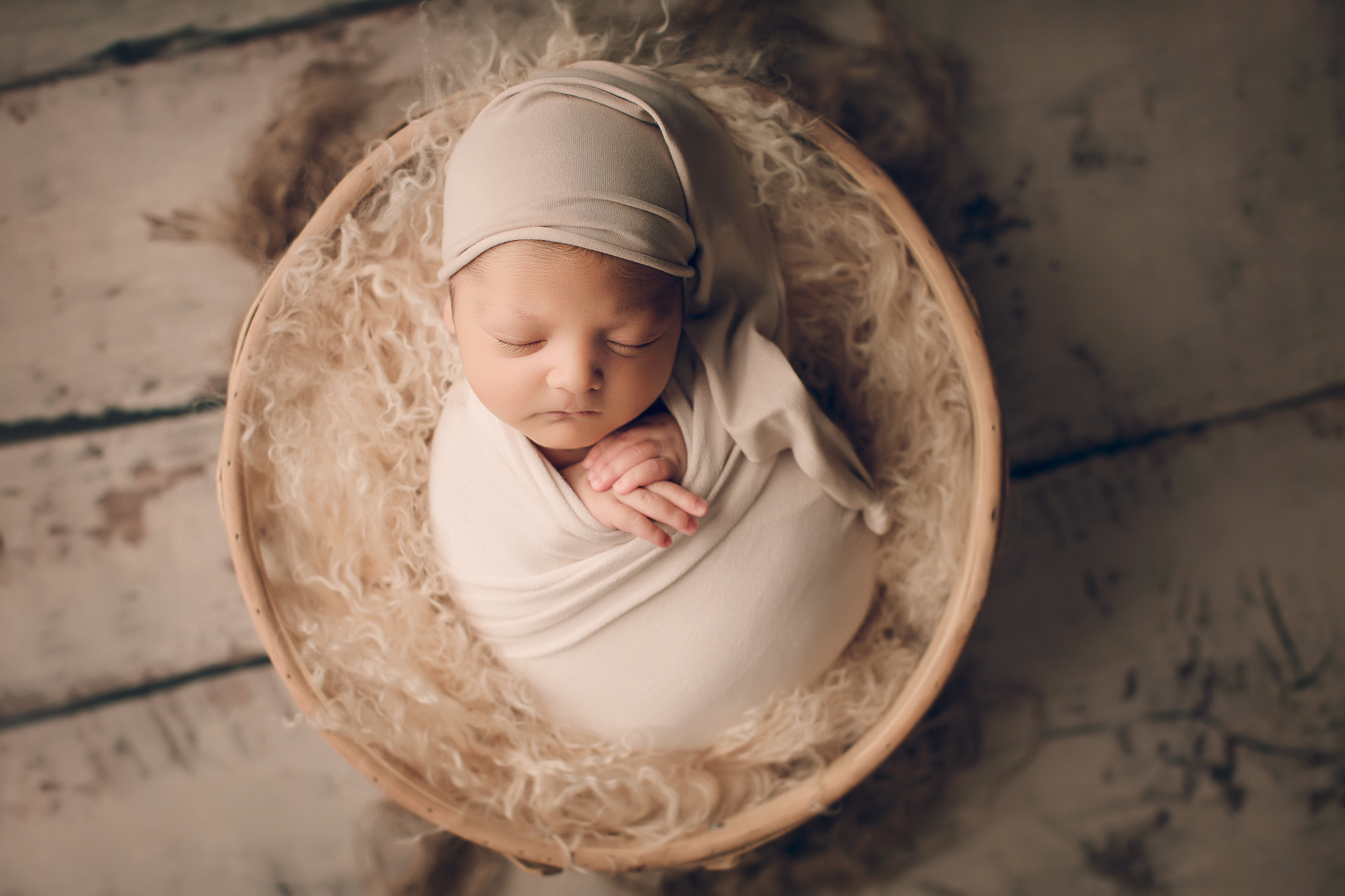 Adelaide Newborn photography photo of a newborn baby asleep in a basket.