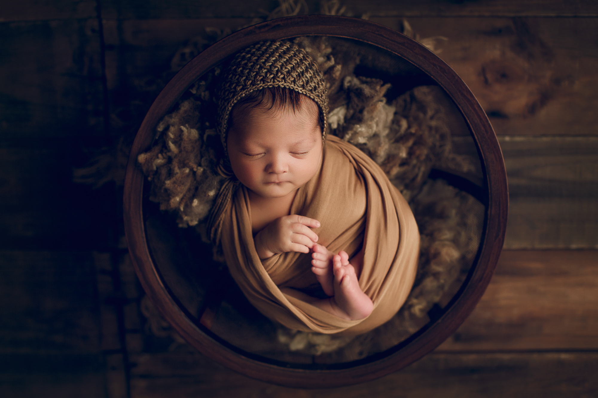 Adelaide Newborn photography photo of a newborn baby asleep in a basket.