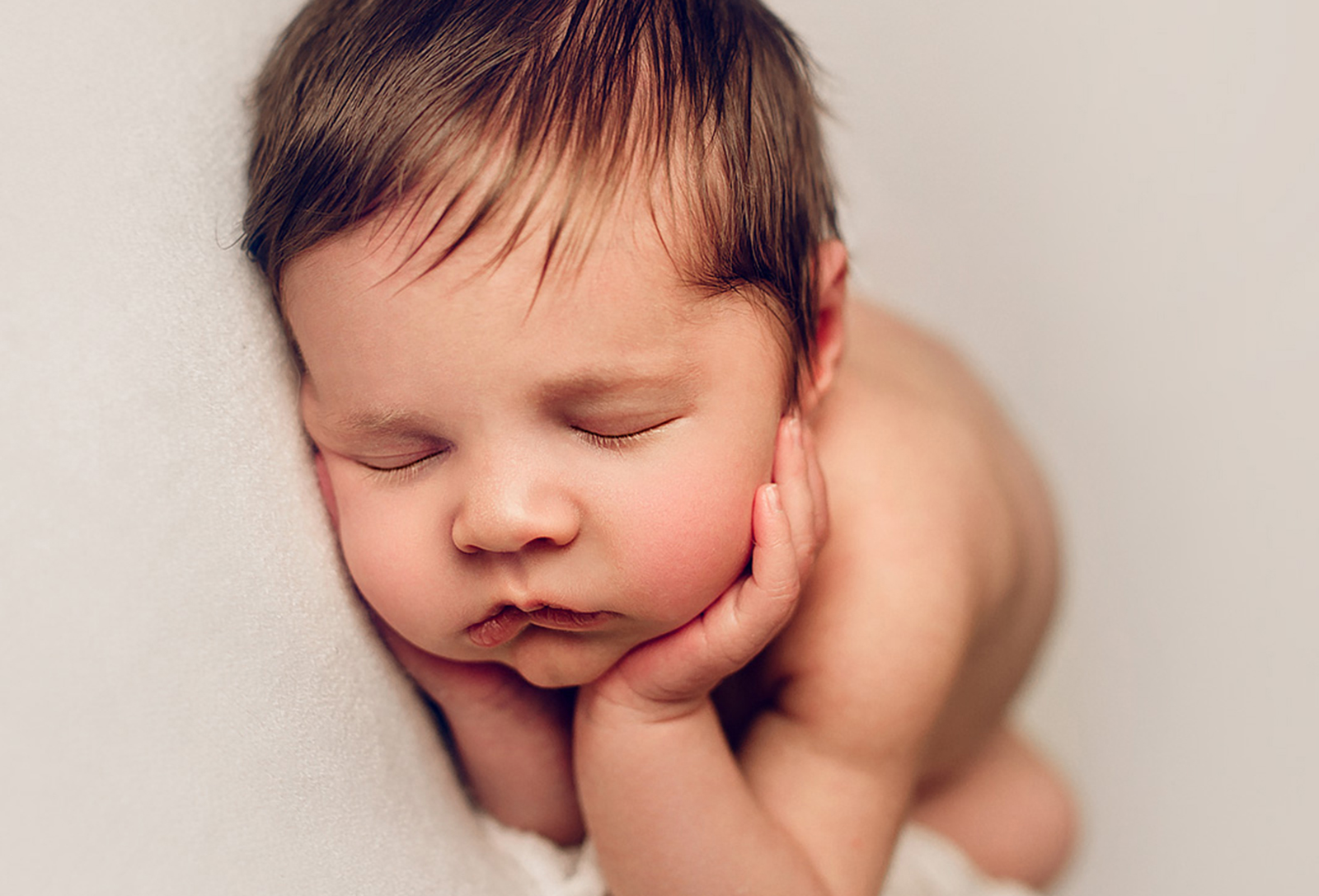 Adelaide newborn baby photographer's photo of a newborn baby boy on a white background..