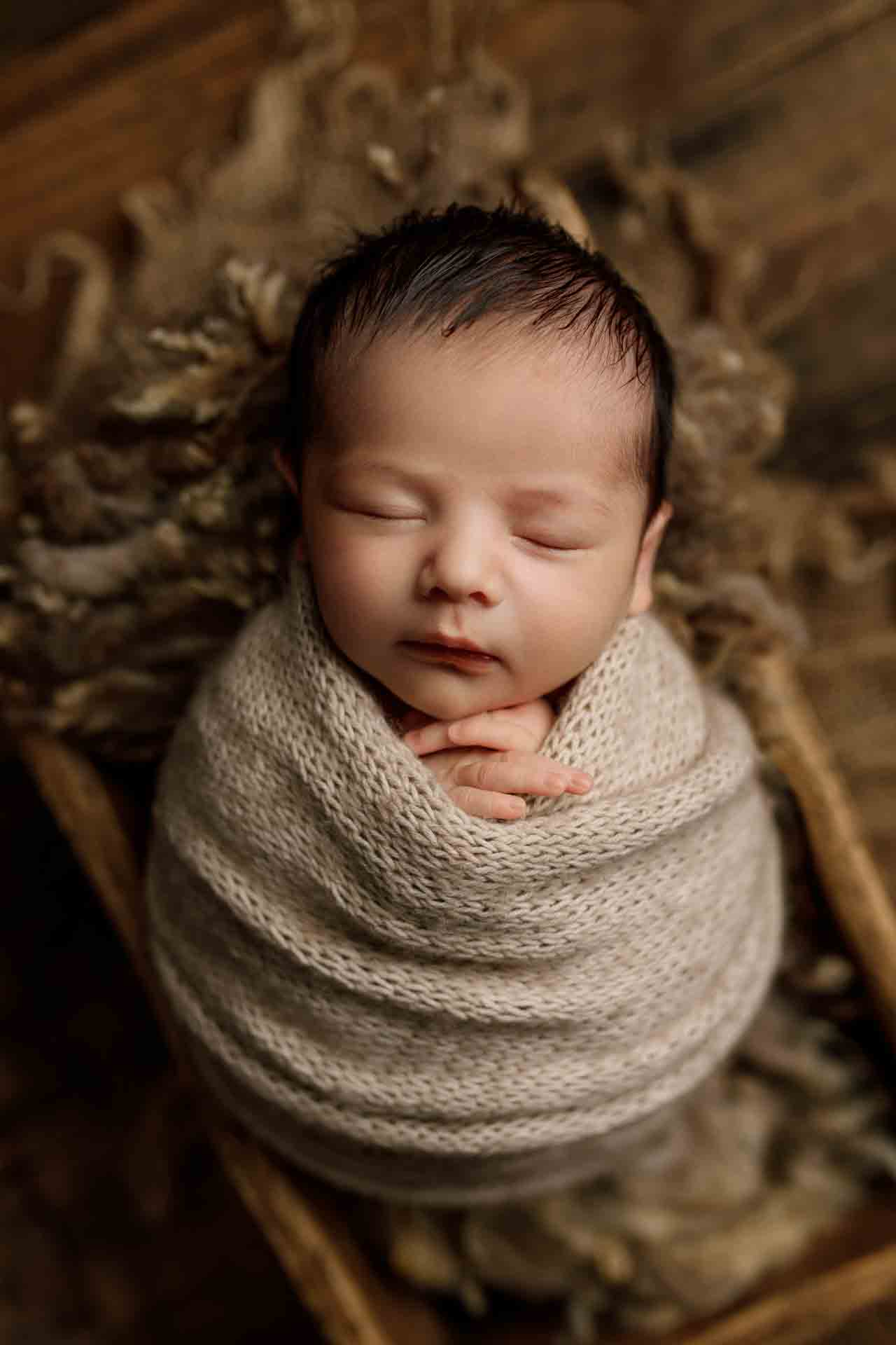 Adelaide newborn baby photographer's photo of a newborn baby boy wrapped up in a crate