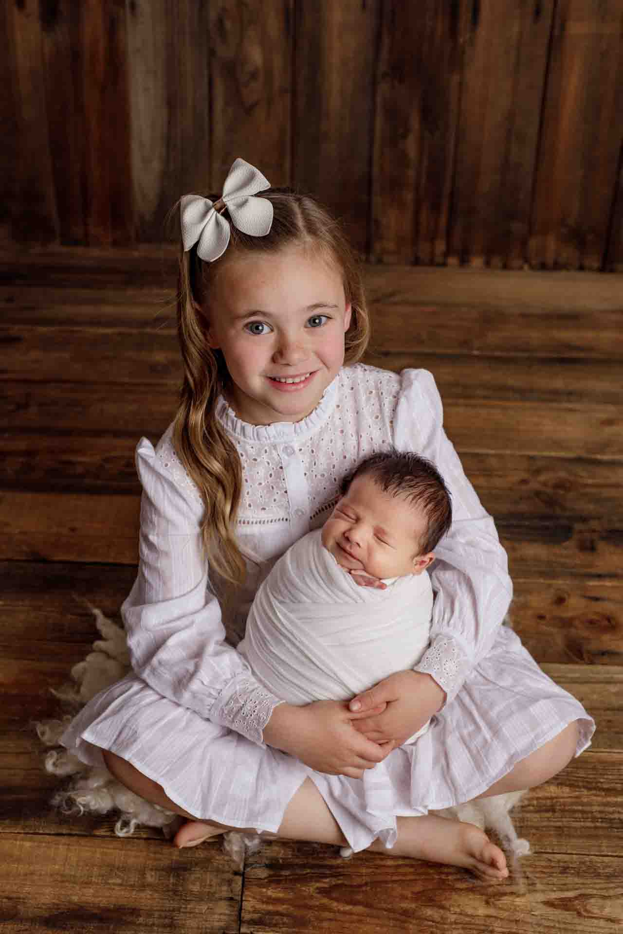 Adelaide newborn baby photographer's photo of a newborn baby boy with his sister.