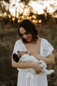 An Adelaide mum with their newborn baby at an outdoor photography session.