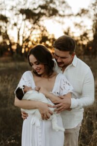 An Adelaide mum and dad with their newborn baby at an outdoor photography session.