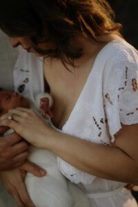 An Adelaide mum with their newborn baby at an outdoor photography session.