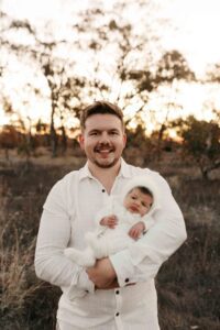 An Adelaide dad with their newborn baby at an outdoor photography session.