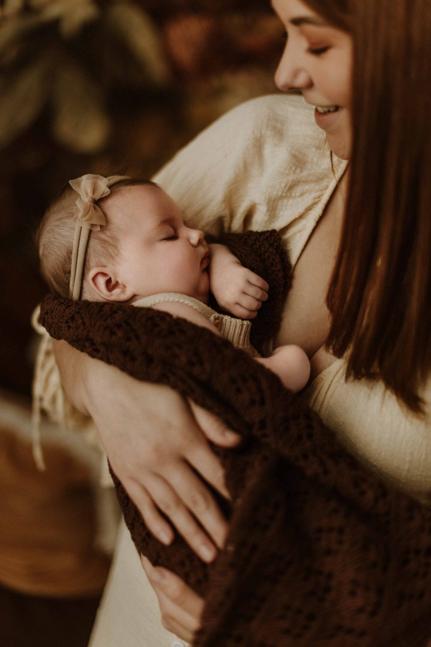 A mum cuddling with her 12 week old baby girl in an Adelaide newborn studio.