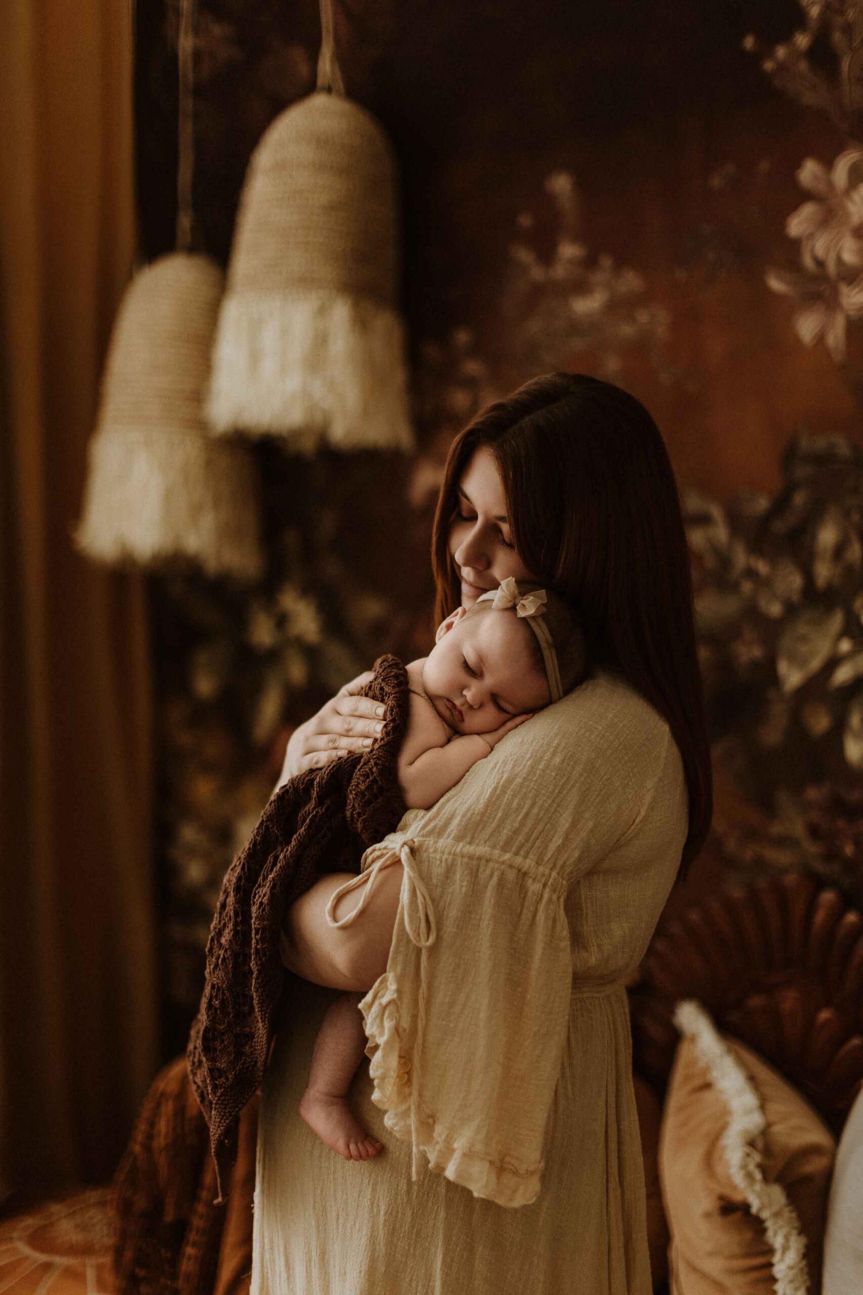 A mum cuddling with her 12 week old baby girl in an Adelaide newborn studio.