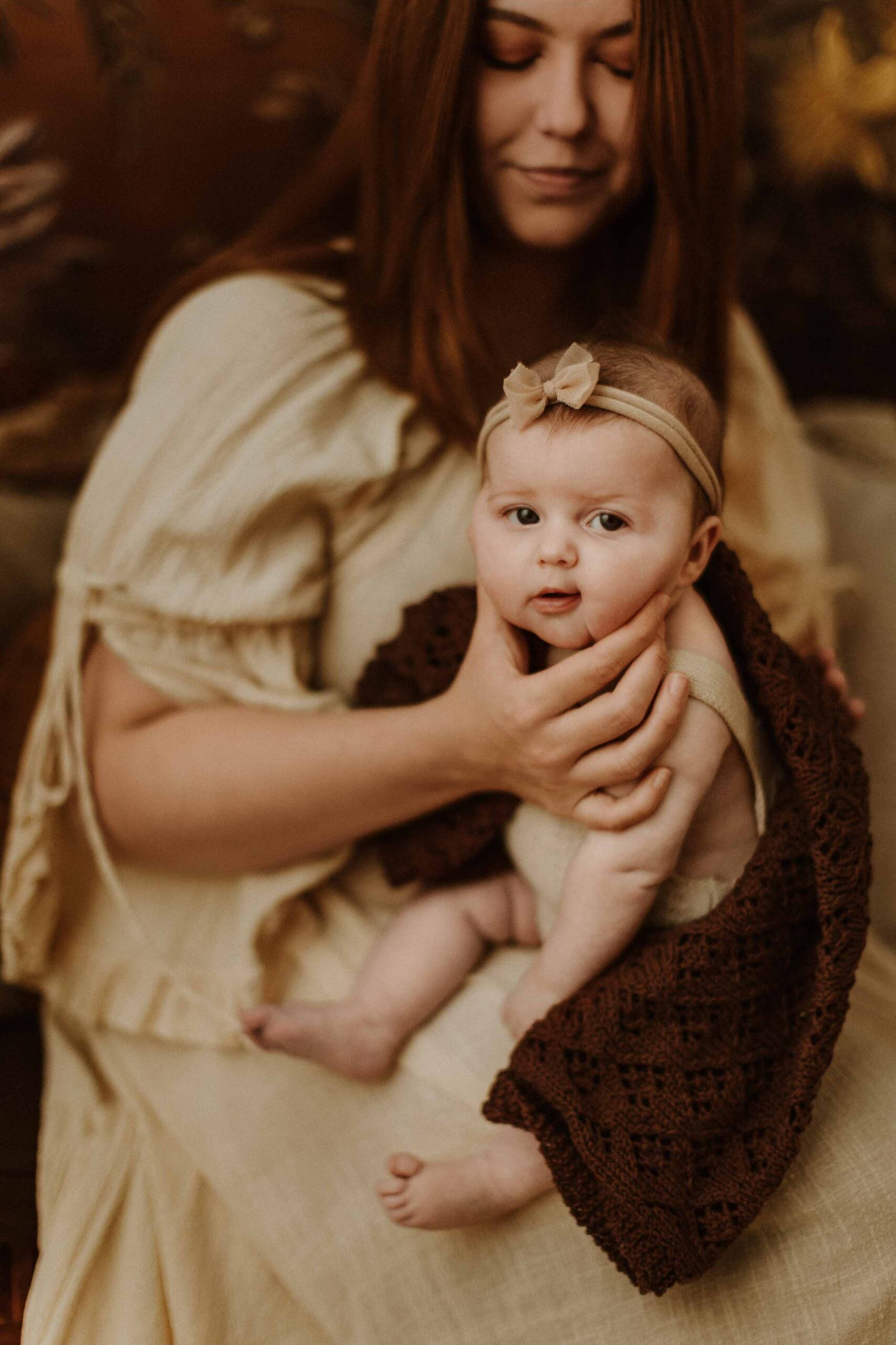 An Adeliade mum holding up her 12 week old baby and giving her a burp.