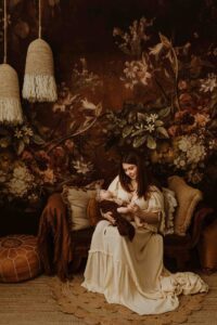 A mum cuddling with her 12 week old baby girl in an Adelaide newborn studio.