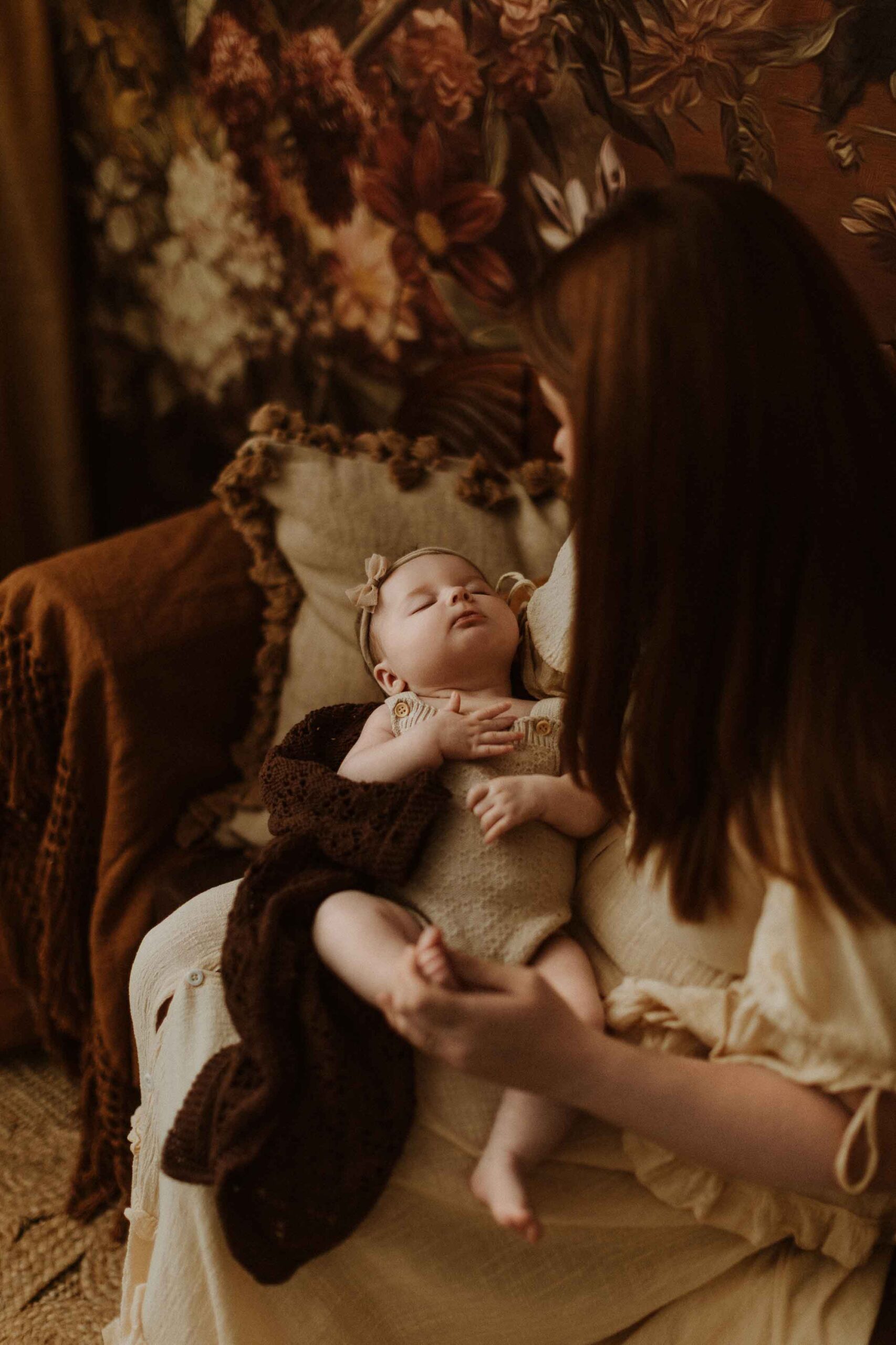 A mum cuddling with her 12 week old baby girl in an Adelaide newborn studio.