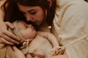 An Adelaide mum cuddling with her 12 week old baby girl.