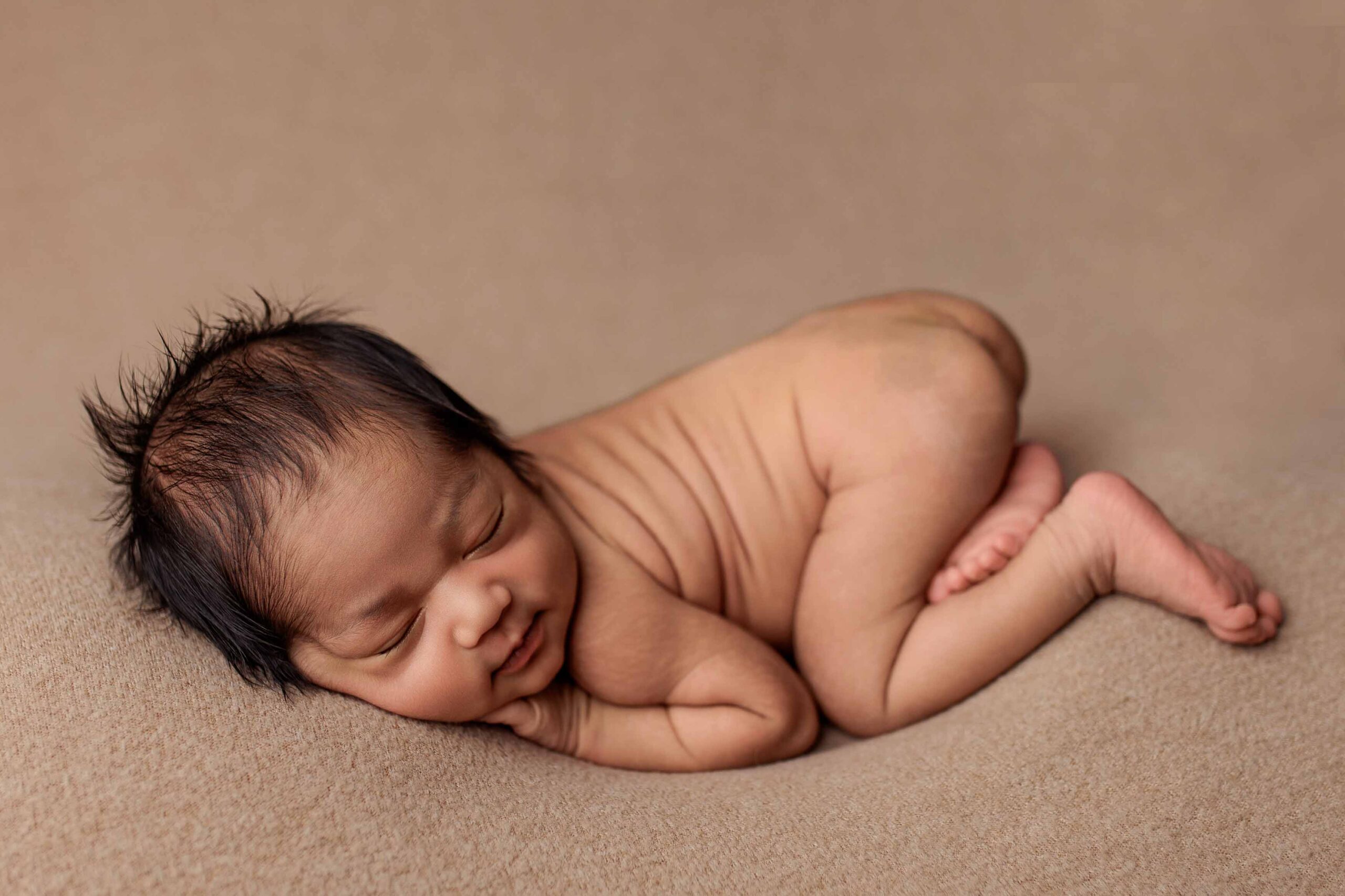 A baby from the Adelaide hills asleep on a blanket.
