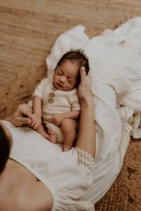 An Adelaide newborn baby sitting in his Adelaide mums lap.