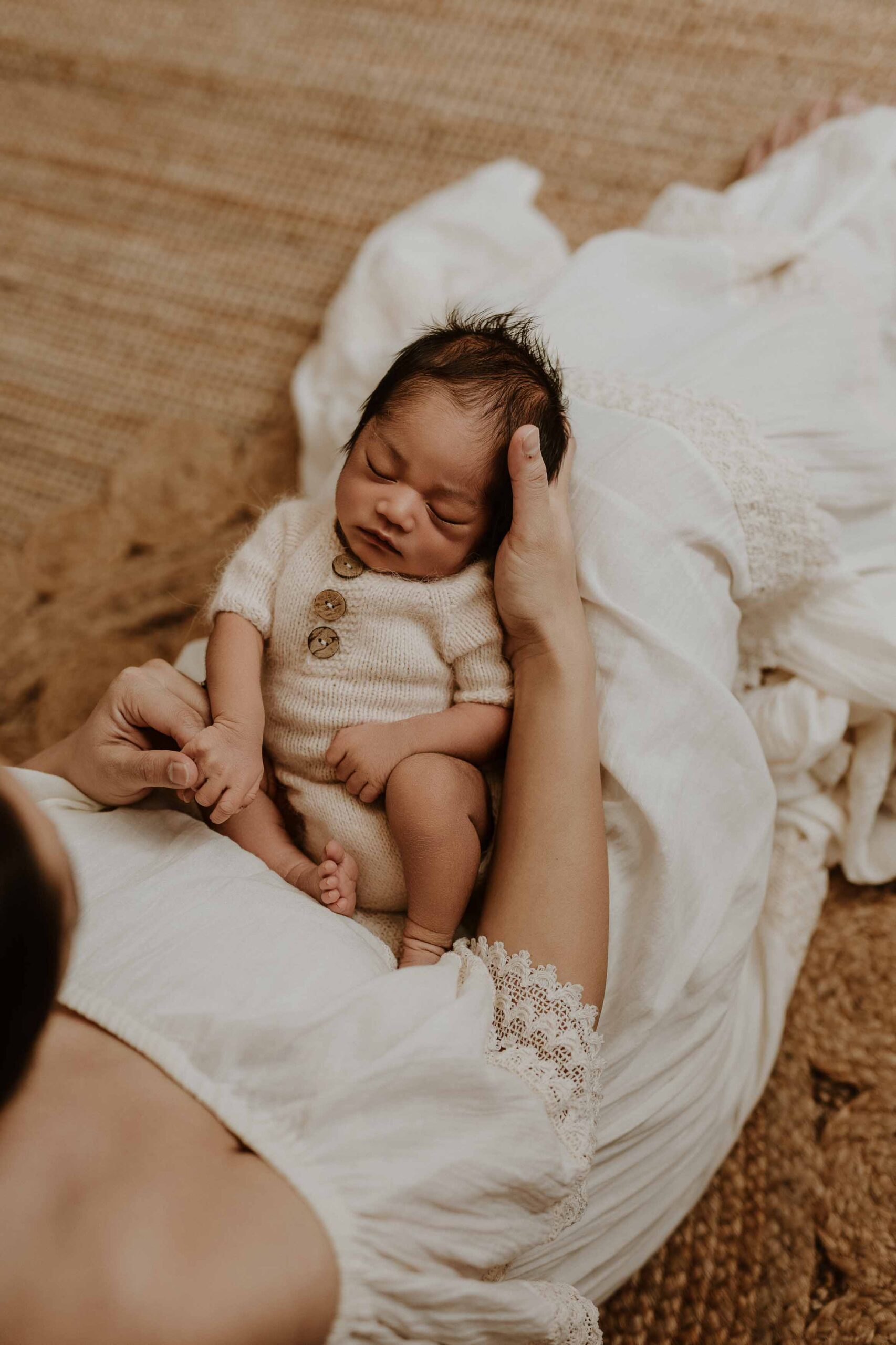 An Adelaide newborn baby sitting in his Adelaide mums lap.