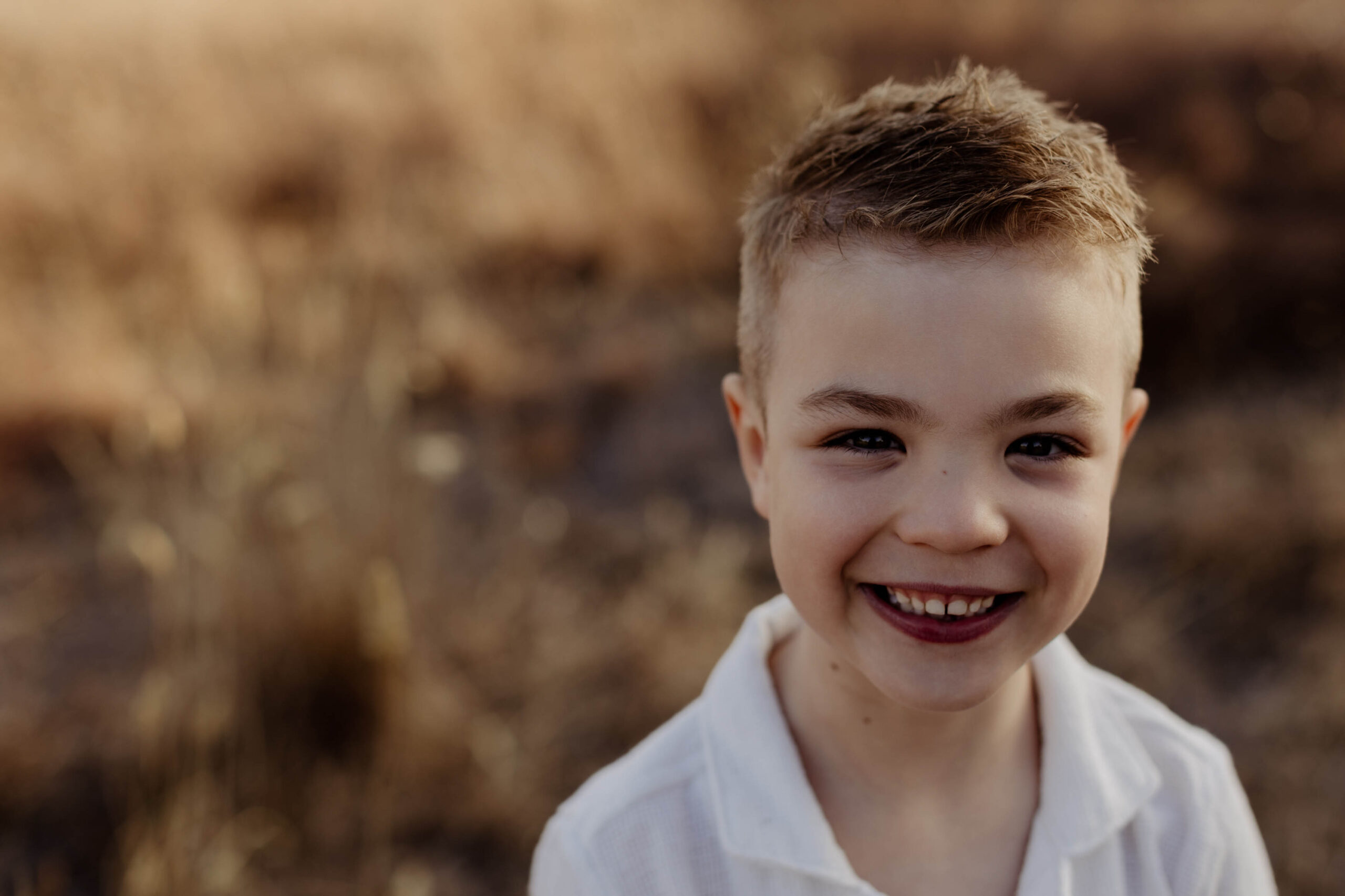 Natural child portrait of a boy smiling during an Adelaide family photography session.