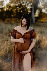 A mum from Adelaide looking at her pregnant belly.