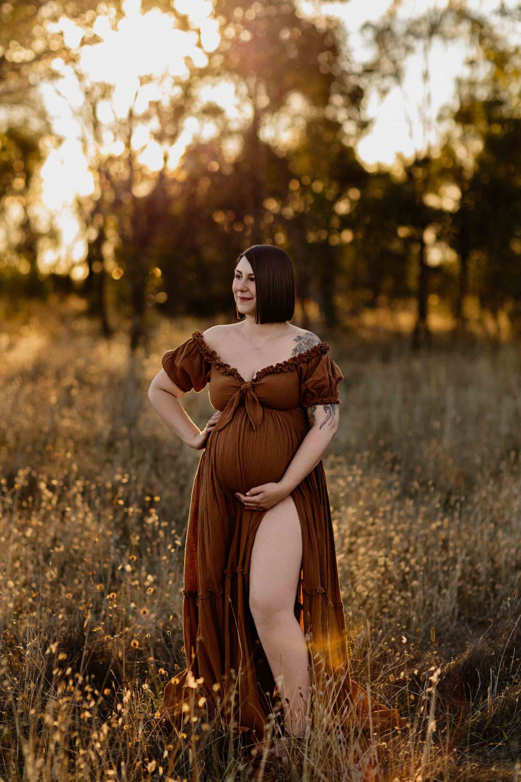 A mum from Adelaide looking to the side wearing a rust dress.