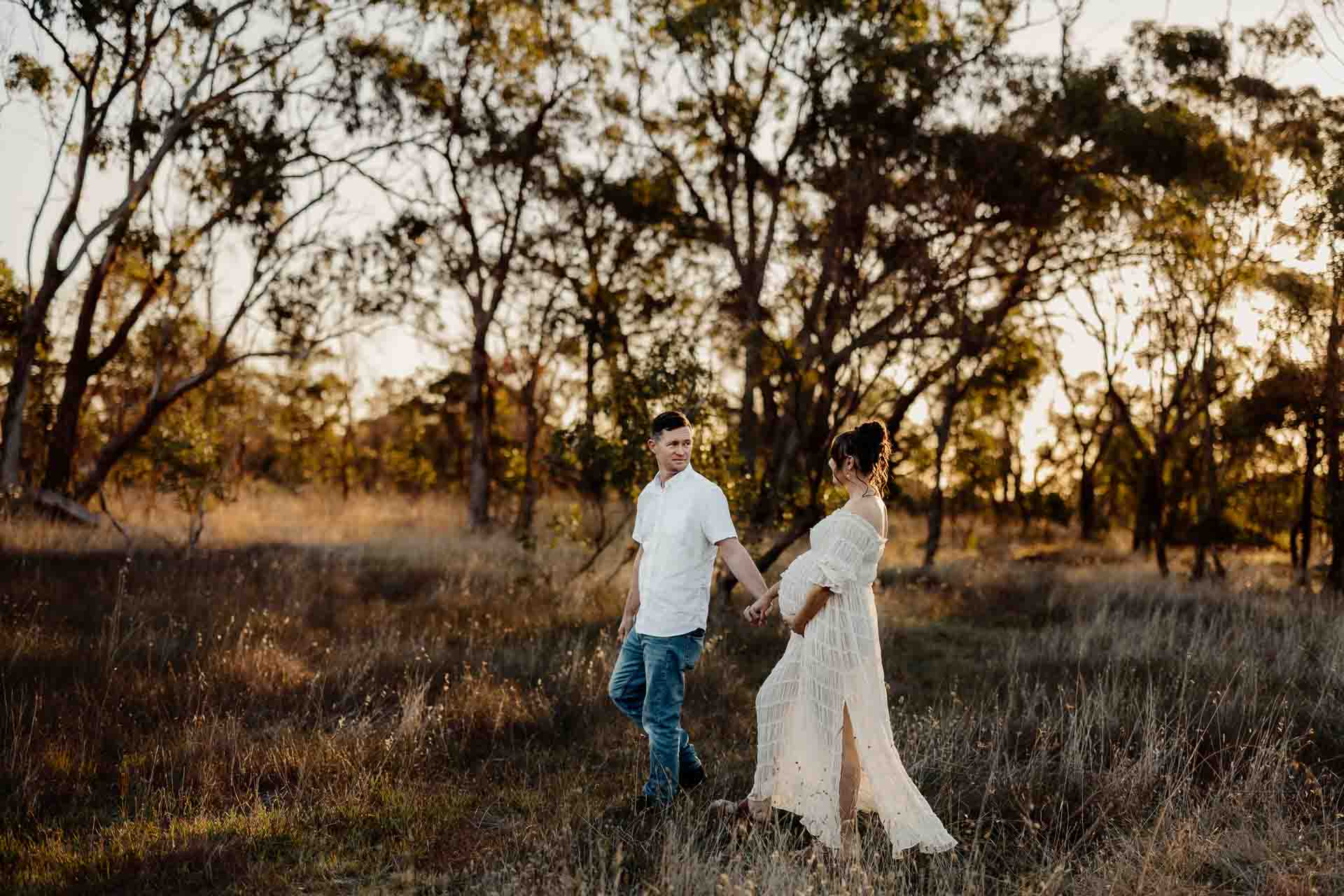 A pregnant mother and her partner walking at a maternity session in Adelaide.