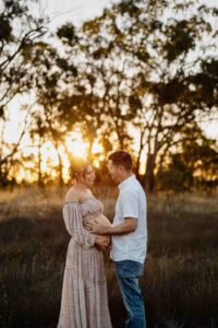 A pregnant mother and her partner in sunlight at a maternity session in Adelaide.