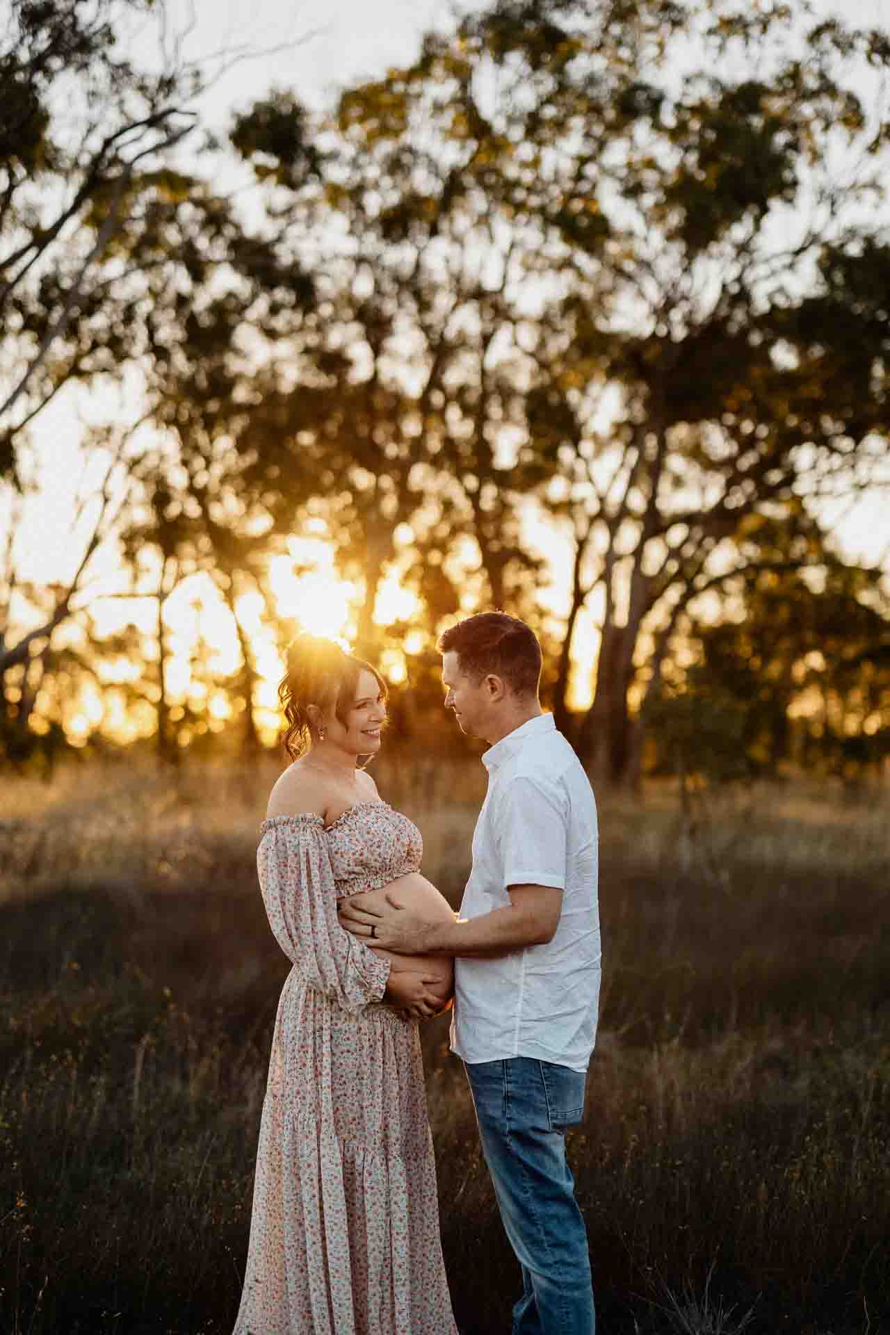A pregnant mother and her partner in sunlight at a maternity session in Adelaide.