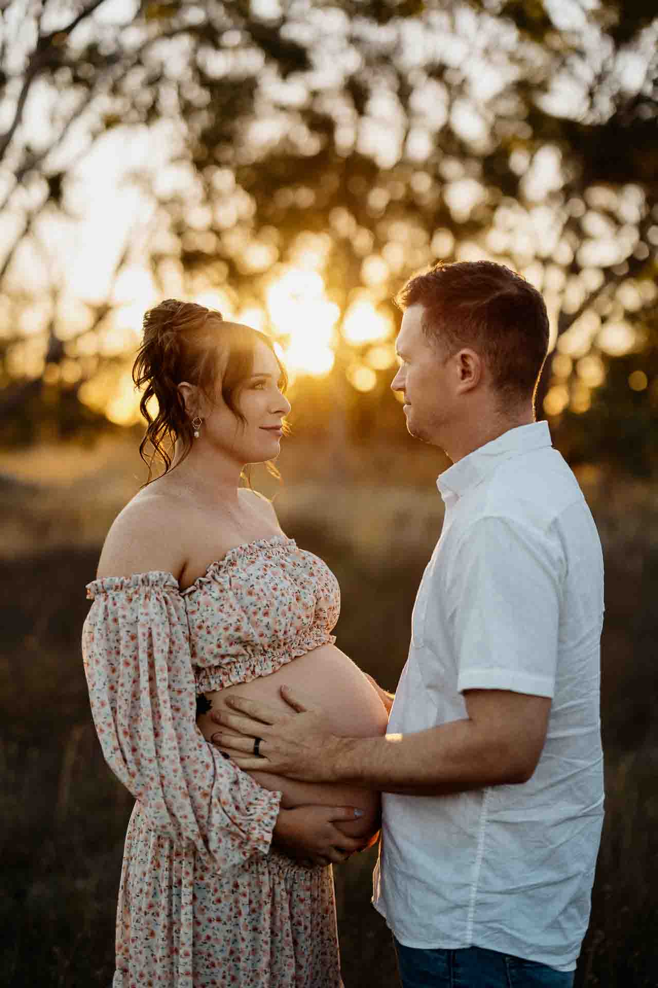 A pregnant mother and her partner looking at each other at a maternity session in Adelaide.