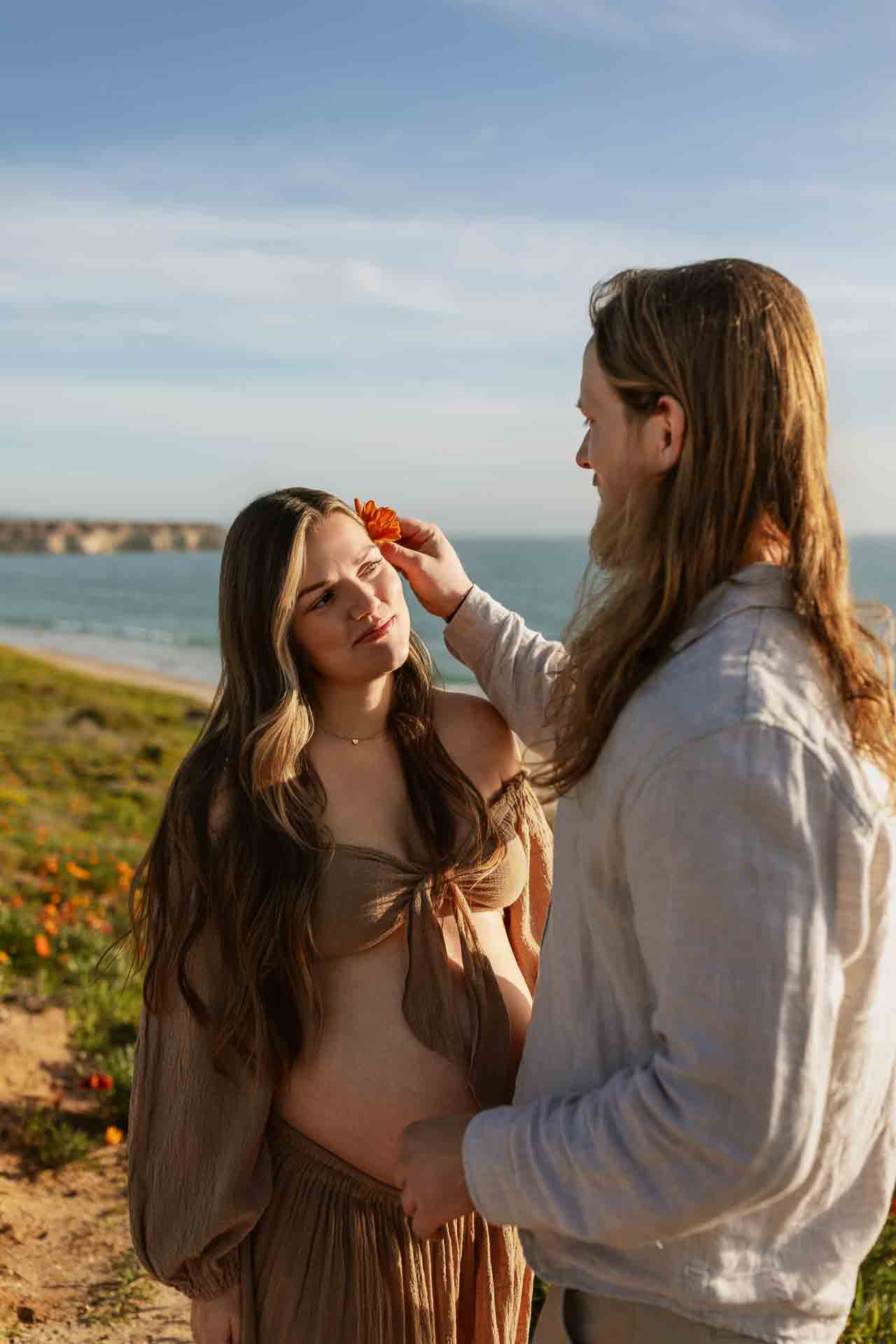 Couple sharing a moment during a beach maternity session on the Adelaide coast