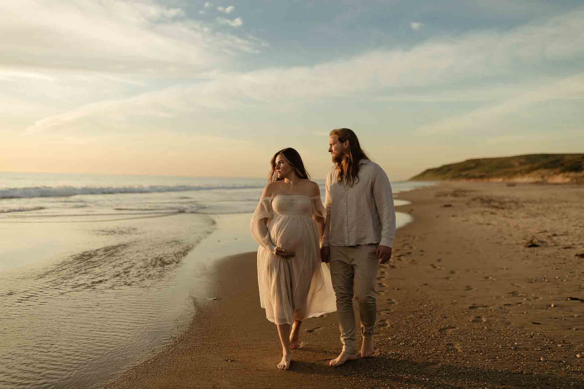 Couple walking along the beach during an Adelaide maternity photography session